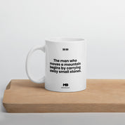 The man who moves a mountain begins by carrying away small stones mug